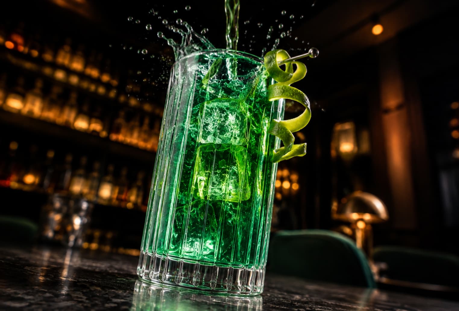 The same emerald cocktail photographed from a dramatic low-angle perspective